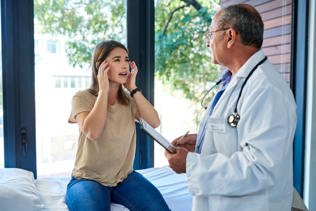 Teenage Girl Consulting with doctor for headache treatment