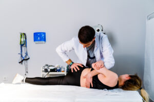 Lady Patient Getting therapy for his lower back pain right side