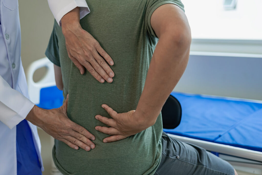 doctor treat patient for back pain