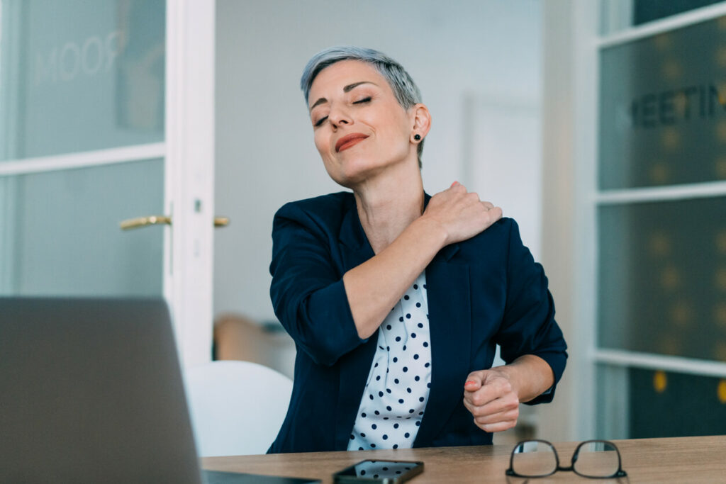 A young woman experiencing back pain.